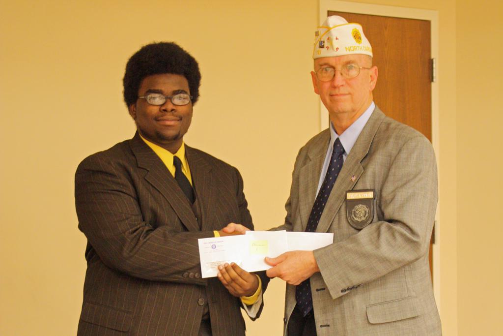 Tyheim Brown receiving his first place check from Division 1 Commander James Ervin. Tyheim precedes on to the State finals.